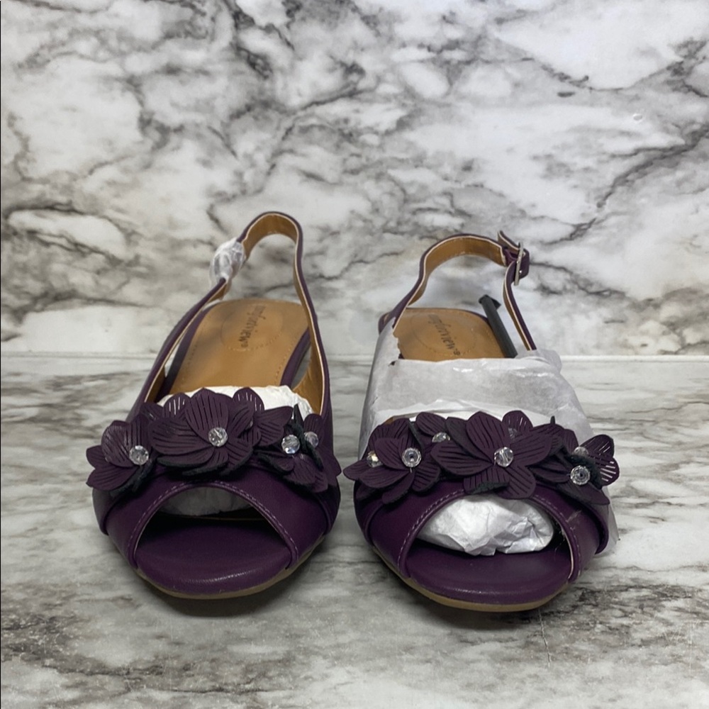 Purple open-toe sandals with a decorative ruffle and low heel